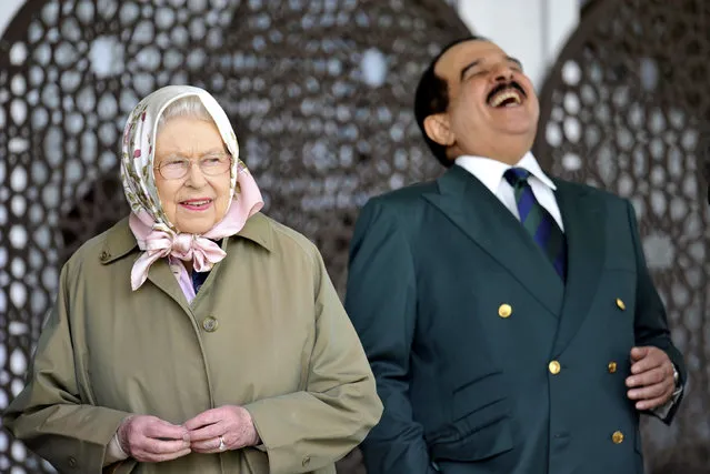 The King of Bahrain Hamad bin Isa Al Khalifa, laughs as he stands with Britain's Queen Elizabeth II  as they attend  the Royal Windsor Horse Show, which is held in the grounds of Windsor Castle in Windsor England  Friday May 12, 2017. (Photo by Nick Ansell/PA Wire via AP Photo)