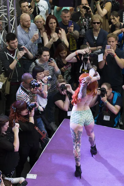 A model poses on the mainstage during the Vintage Alternative Fashion Show at The Great British Tattoo Show at Alexandra Palace on May 24, 2014 in London, England. (Photo by Tristan Fewings/Getty Images for Alexandra Palace)