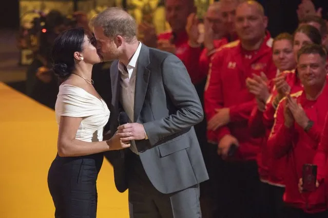 Prince Harry and Meghan Markle, Duke and Duchess of Sussex, kiss during the opening ceremony of the Invictus Games venue in The Hague, Netherlands, Saturday, April 16, 2022. The week-long games for active servicemen and veterans who are ill, injured or wounded opens Saturday in this Dutch city that calls itself the global center of peace and justice. (Photo by Peter Dejong/AP Photo)