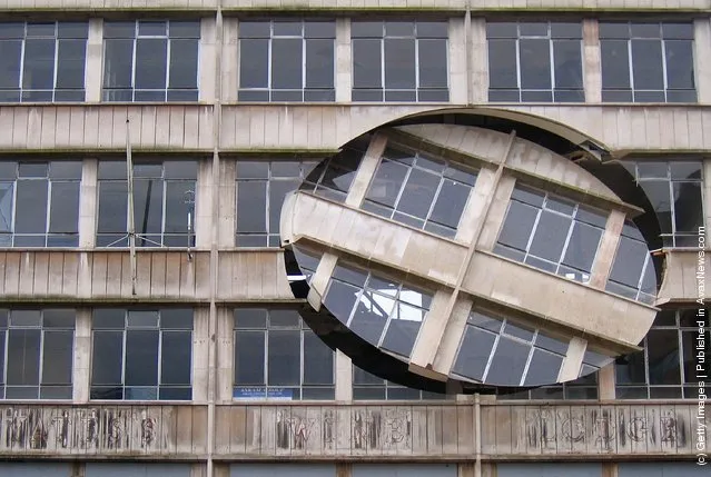 An installation by the artist Richard Wilson, entitled 'Turning the Place Over', is built into the condemned Cross Keys House in Moorfields as part of the Capital of Culture for 2008