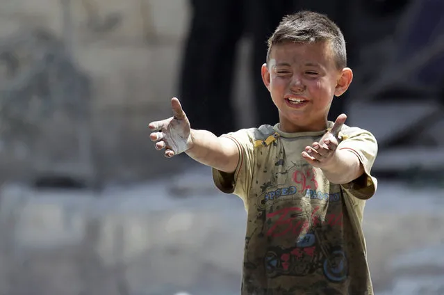 A boy, whose brother was killed, reacts at a site hit by airstrikes in the rebel-controlled area of Maaret al-Numan town in Idlib province, Syria June 2, 2016. (Photo by Khalil Ashawi/Reuters)