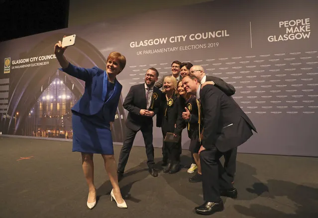 Scottish First Minister Nicola Sturgeon takes a photo with party members at the SEC Centre in Glasgow after the declaration in her constituency in the 2019 general election, Friday December 13, 2019. An exit poll in Britain's election projects that Prime Minister Boris Johnson's Conservative Party likely will win a majority of seats in Parliament. That outcome would allow Johnson to fulfil his plan to take the U.K. out of the European Union next month. (Photo by Scott Heppell/AP Photo)