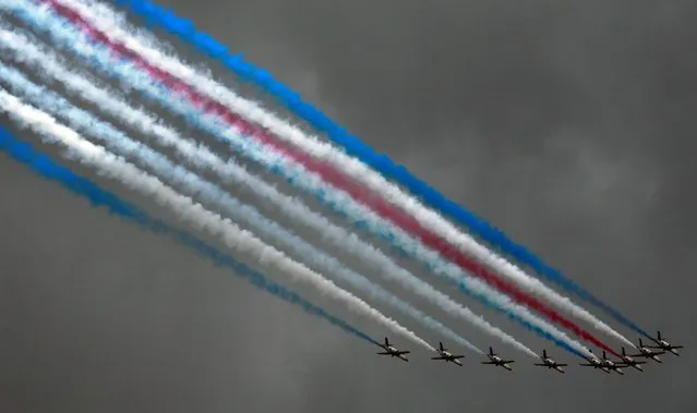 AT-3 jets fly in formation with colored smoke during a ceremony marking the 90th anniversary of Taiwan's military academy in Kaohsiung, Taiwan, Monday, June 16, 2014. (Photo by Wally Santana/AP Photo)