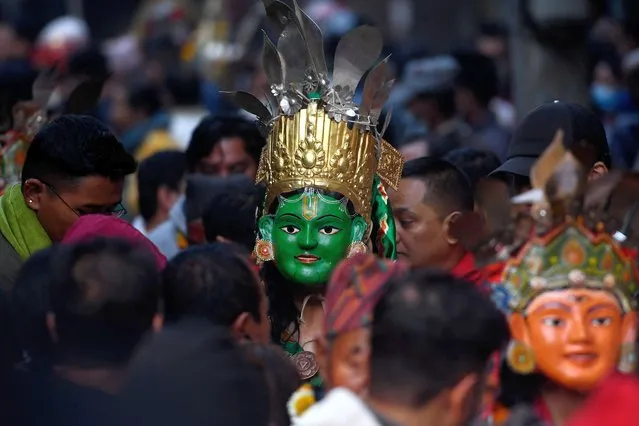 Masked dancers dressed as deities take part in a procession during the Naradevi Swetkali festival in Kathmandu on March 28, 2022. (Photo by Prakash Mathema/AFP Photo)