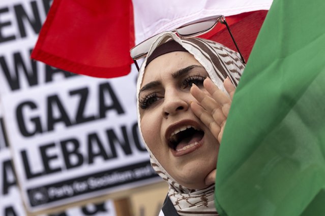 A protester waves a Lebanese flag as demonstrators gather to protest against the war on Gaza and Israeli military strikes on Lebanon in front of the Los Angeles Federal Building on Tuesday, September 24, 2024, in Los Angeles. (Photo by Etienne Laurent/AP Photo)