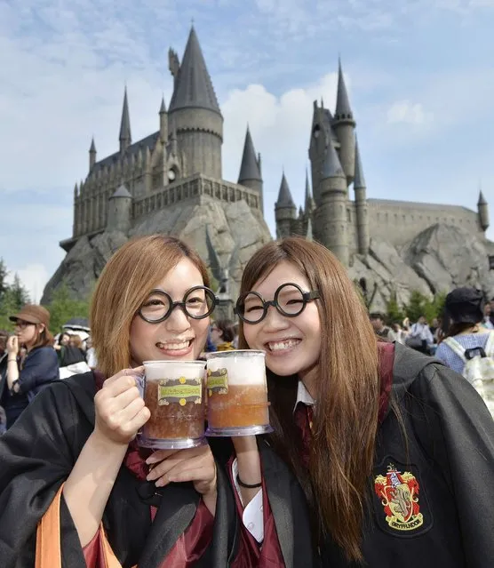 Women pose for pictures in front of Universal Studios Japan's new attraction “The Wizarding World of Harry Potter” as it is opened to the public at Universal Studios Japan in Osaka, in this photo taken by Kyodo July 15, 2014. (Photo by Reuters/Kyodo)