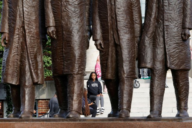 A student at North Carolina A&T State University, the state’s largest Historically Black College and University (HBCU), is framed by a statue of the Greensboro Four, students who in 1960 staged one of the first sit-ins at a segregated restaurant in the United States, as she waits in line to cast her ballot at an early voting site on campus, in Greensboro, North Carolina on October 28, 2024. (Photo by Jonathan Drake/Reuters)