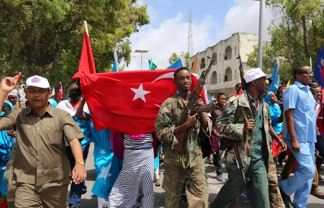 Somali people carry Turkish flags as they chant slogans in support of Turkish President Tayyip Erdogan and his government in Somalia's capital Mogadishu, July 16, 2016. (Photo by Feisal Omar/Reuters)