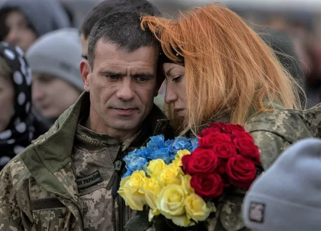 Sergey Zhelisko is hugged as his son, Ukrainian soldier Dmitry Zhelisko is buried on April 03, 2022 in Rusyn, Ukraine. Zhelisko died fighting the Russian army near the town of Kharkiv. More than five weeks since the Russian invasion began, Ukraine's military losses are still unclear, with the last official account coming on March 12, when the government acknowledged that 1,300 Ukrainian soldiers had been killed. (Photo by Joe Raedle/Getty Images)