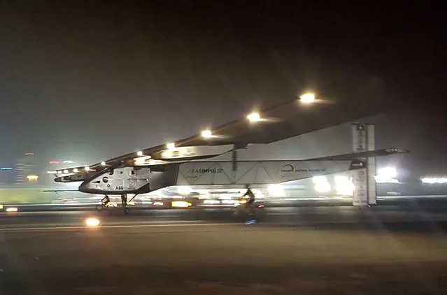 The Solar Impulse 2 plane lands in an airport in Abu Dhabi, United Arab Emirates, early Tuesday, July 26, 2016, marking the historic end of the first attempt to fly around the world without a drop of fuel, powered solely by the sun’s energy. Solar Impulse Chairman and pilot Bertrand Piccard was at the controls of the single-seater when it landed at the Al Bateen Executive Airport. Piccard traded off piloting with co-founder Andre Borschberg in the epic journey that took more than a year to complete. (Photo by Aya Batrawy/AP Photo)