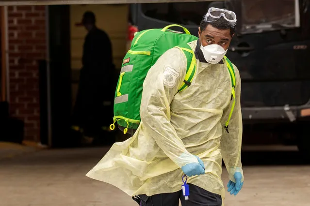 An Emergency Medical Technician (EMT) wearing personal protective equipment (PPE) walks out of the Cobble Hill Health Center nursing home during the ongoing outbreak of the coronavirus disease (COVID-19) in the Brooklyn borough of New York, U.S., April 17, 2020. (Photo by Lucas Jackson/Reuters)