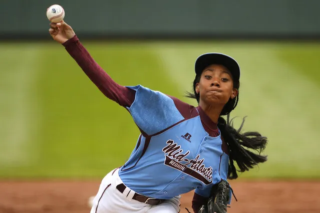 In this August 15, 2014, file photo, Pennsylvania's 13-year-old Mo'ne Davis delivers in the first inning against Tennessee during a baseball game in United States pool play at the Little League World Series tournament in South Williamsport, Pa. Little League is getting younger. The organization announced Thursday, September 10, 2015, it is changing its age requirement, phasing out 13-year-olds from the league. (Photo by Gene J. Puskar/AP Photo)