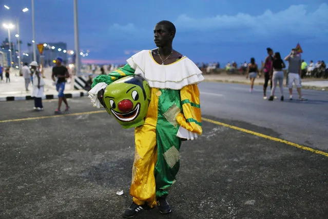A reveller stands at Havana's Malecon seafront before performing at a carnival parade, Cuba, August 12, 2016. (Photo by Alexandre Meneghini/Reuters)