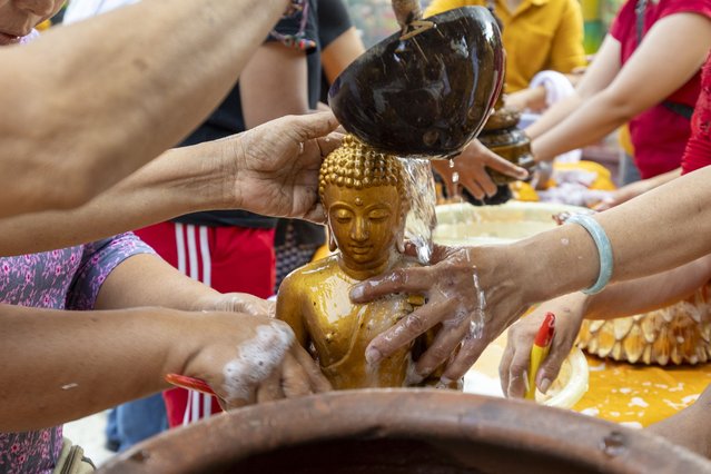 People wash a statue during preparations for the upcoming Lunar New Year at a temple in Kuta, Bali, Indonesia, 23 January 2025. The Chinese Lunar New Year, locally known as “Imlek” and also known as the Spring Festival in China, falls on 29 January, marking the beginning of the Year of the Snake. (Photo by Made Nagi/EPA)