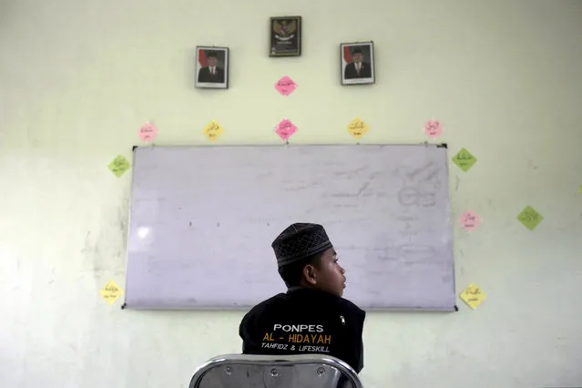 In this July 22, 2017, photo, a student sits in a classroom at Al Hidayah Islamic Boarding School in Sei Mencirim, North Sumatra, Indonesia. Pupils at the boarding school are the sons of Islamic militants whose fathers were killed in police raids or are in prison for terrorism offenses. Former radical preacher Khairul Ghazali set founded the school to prevent the boys, who were ostracized and taunted at mainstream schools, from becoming the next generation of Indonesian jihadists. (Photo by Binsar Bakkara/AP Photo)