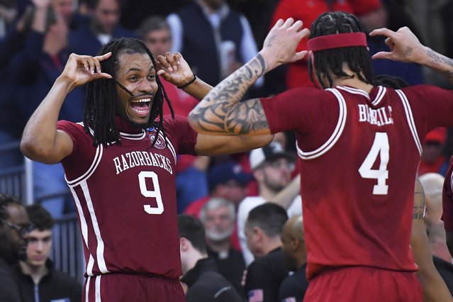Arkansas forward Jonas Aidoo (9) celebrates with Trevon Brazile (4) after defeating Kansas after their game in the first round of the NCAA college basketball tournament, Thursday, March 20, 2025, in Providence, R.I. (Photo by Steven Senne/AP Photo)
