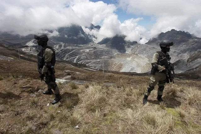 Indonesian police stand guard at the open-pit mine of PT Freeport's Grasberg copper and gold mine complex near Timika, in the eastern province of Papua, Indonesia September 19, 2015 in this photo taken by Antara Foto. (Photo by Muhammad Adimaja/Reuters/Antara Foto)