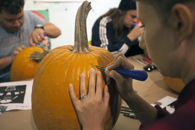 An attendee of the workshop made the first incision on her pumpkin at Cotton Candy Machine in Brooklyn, N.Y. on October 18, 2014. (Photo by Siemond Chan/Yahoo Finance)