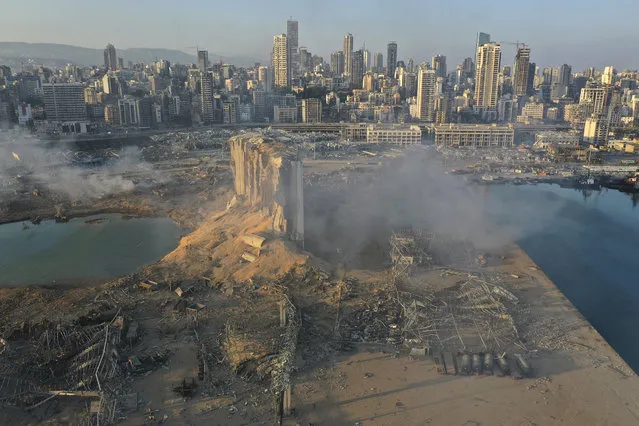 A drone picture shows the scene of an explosion at the seaport of Beirut, Lebanon, Wednesday, August 5, 2020. A massive explosion rocked Beirut on Tuesday, flattening much of the city's port, damaging buildings across the capital and sending a giant mushroom cloud into the sky. More than 70 people were killed and 3,000 injured, with bodies buried in the rubble, officials said. (Photo by Hussein Malla/AP Photo)