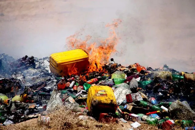 Afghan officials burn the expired drugs and food items in Helmand, Afghanistan, 23 June 2020. (Photo by Watan Yar/EPA/EFE)