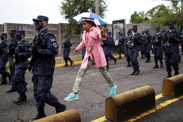 A girl marches alongside Salvadoran soldiers during the parade commemorating Independence Day  in San Salvador, El Salvador September 15, 2016. (Photo by Jose Cabezas/Reuters)