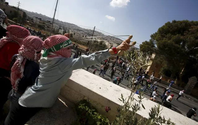 A Palestinian girl uses a slingshot to throw stones at Israeli troops during clashes in the West Bank city of Bethlehem October 14, 2015. Seven Israelis and 30 Palestinians, including children and assailants, have been killed in two weeks of bloodshed in Israel, Jerusalem and the occupied West Bank. (Photo by Mussa Qawasma/Reuters)