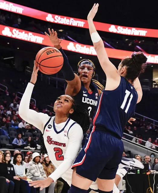 St. John's Mimi Reid (2) drives past Connecticut's Aaliyah Edwards (3) and St. John's Sitota Gines (11) during the first half of an NCAA basetball game Wednesday, January 11, 2023, in New York. (Photo by Frank Franklin II/AP Photo)