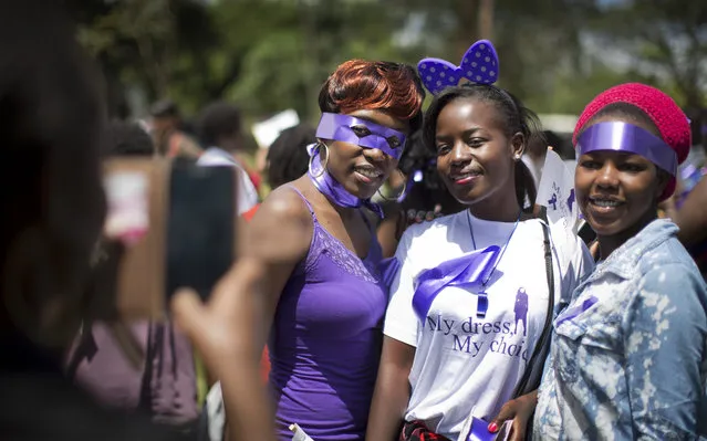 Kenyan women protesters pose for a friend to take a picture of them, as they demonstrate for the right to wear whichever clothes they want, at a demonstration in downtown Nairobi, Kenya Monday, November 17, 2014. (Photo by Ben Curtis/AP Photo)