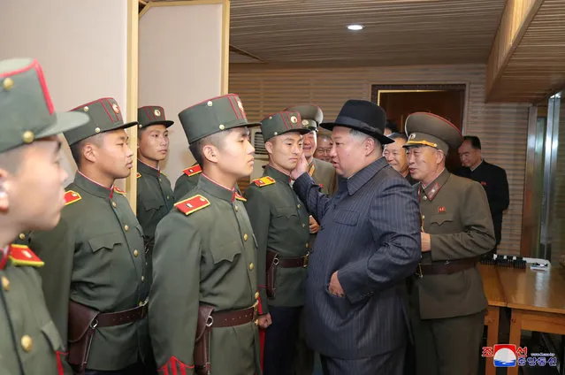This picture taken on October 16, 2022 and released from North Korea's official Korean Central News Agency (KCNA) on October 17, 2022 shows North Korea's leader Kim Jong Un (centre R) visiting the Mangyongdae Revolutionary Academy in Pyongyang. (Photo by KCNA via KNS/AFP Photo)