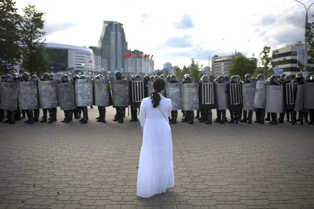 A woman wearing white, stands in front of a riot police line during a Belarusian opposition supporters' rally protesting the official presidential election results in Minsk, Belarus, Sunday, September 13, 2020. (Photo by TUT.by via AP Photo)