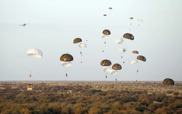 French paratroopers drop from a plane over Timbuktu airport in Mali, on January 29, 2013. (Photo by Olivier Debes/AP Photo/ECPAD/The Atlantic)