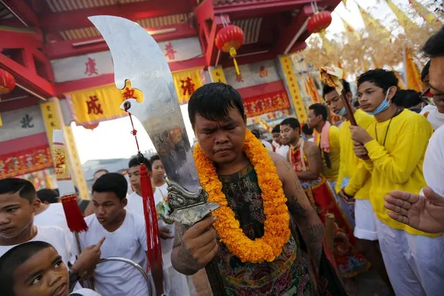 Devotees of the Chinese Jui Tui shrine walk during a procession celebrating the annual vegetarian festival in Phuket, Thailand October 19, 2015. (Photo by Jorge Silva/Reuters)