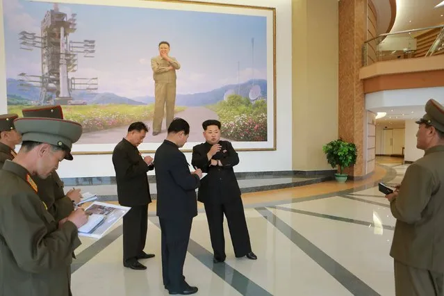 North Korean leader Kim Jong Un (centre R) provides field guidance at the newly built National Space Development General Satellite Control and Command Centre in this undated photo released by North Korea's Korean Central News Agency (KCNA) in Pyongyang May 3, 2015. (Photo by Reuters/KCNA)