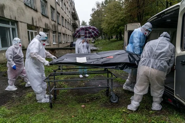 Medical workers move the body of a patient who died from the coronavirus at a hospital in Stebnyk, Ukraine, on Wednesday, September 30, 2020. (Photo by Evgeniy Maloletka/AP Photo)