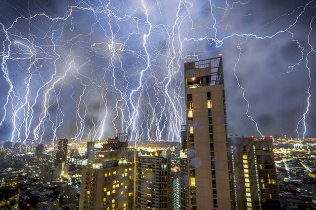 Multiple lightning strikes are seen in this 66 image composite taken over 1.5 hours during a monsoon in Bangkok, Thailand which took place overnight from October 29th to October 30th, 2024. The monsoon season in Bangkok normally lasts from July to October, making this one of the year's last major storms to hit the Thai capital. (Photo by Adryel Talamantes/ZUMA Press Wire/Rex Features/Shutterstock)