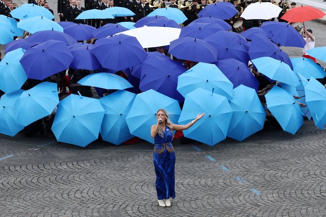 Singer Eloiz sings during a performance dedicated to the 100th anniversary of the Bleuet de France during the annual Bastille Day military ceremony on the Champs-Elysees avenue in Paris, France, on July 14, 2025. (Photo by Gonzalo Fuentes/Reuters)