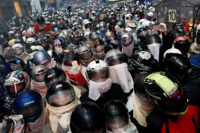 Participants wear motorcycle helmets as they attend the “Beehive Firecrackers” festival at the Yanshui district in Tainan, Taiwan on March 1, 2018. (Photo by Tyrone Siu/Reuters)