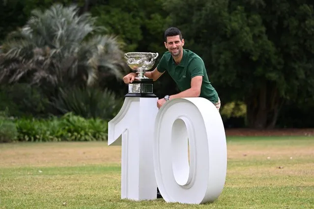 Serbia's Novak Djokovic poses with the Norman Brookes Challenge Cup trophy in Melbourne on January 30, 2023, after winning the Australian Open tennis tournament's mens' singles final against Greece's Stefanos Tsitsipas. (Photo by William West/AFP Photo)