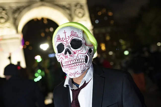 A reveler marches during the Greenwich Village Halloween Parade, Saturday, October 31, 2020, in New York. (Photo by Jeenah Moon/AP Photo)