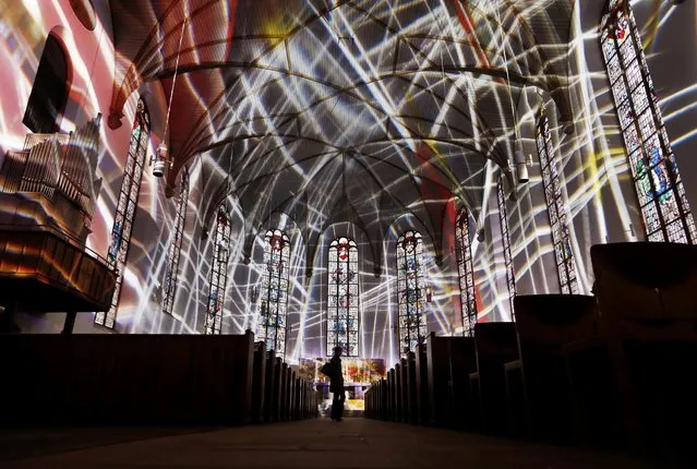 The inside of the Katharinen church is illuminated during a rehearsal for the “Luminale” light festival in Frankfurt, Germany, Friday, March 16, 2018. The “Luminale” with light installations all over the city starts on Sunday. (Photo by Michael Probst/AP Photo)