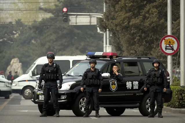 Police in tactical gear block a road leading to the Diaoyutai State Guesthouse in Beijing, Tuesday, March 27, 2018. Unusually heavy security at a Beijing guesthouse where prominent North Koreans have stayed in the past and media reports of a special train arriving have raised speculation that Kim Jong Un is making his first trip to China as North Korea's leader. (Photo by Mark Schiefelbein/AP Photo)