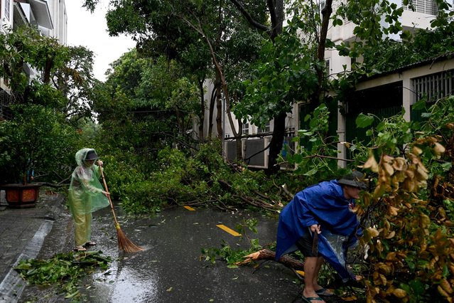People clear up the rubble after Typhoon Kajiki passed through in Nghe An province on August 26, 2025. (Photo by Nhac Nguyen/AFP Photo)
