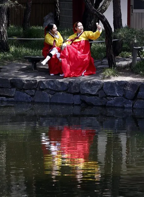 Twenty-year-old South Korean women wearing traditional costumes pose for a selfie prior to the 44th Coming-of-Age Day ceremony at Namsangol Hanok Village in Seoul, South Korea, 16 May 2016. The ceremony marks boys and girls as independent individuals after living under the protection of their families. (Photo by Jeon Heon-Kyun/EPA)