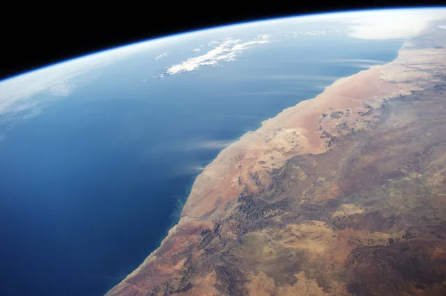 Images of the Namib desert by astronauts on board the International Space Station (ISS) on June 21, 2014 above Namibia. Large dust plumes are visible being carried by strong winds off the coast of the Namib Desert. (Photo by NASA/SPL/Barcroft Media)