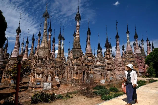 A visitor walks past stupas at the Kakku pagoda complex near Taunggyi township in Myanmar's southern Shan state on March 21, 2023. (Photo by Sai Aung Main/AFP Photo)