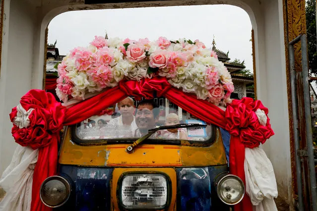 Mr. Kasem rides a tuk-tuk carrying his new ordained sons Apiwvit and Phusit after their heads were shaved at Wat Klang Thung temple in preparation for an annual Poy Sang Long celebration, part of the traditional rite of passage for boys to be initiated as Buddhist novices, in Mae Hong Son, Thailand, April 2, 2018. (Photo by Jorge Silva/Reuters)