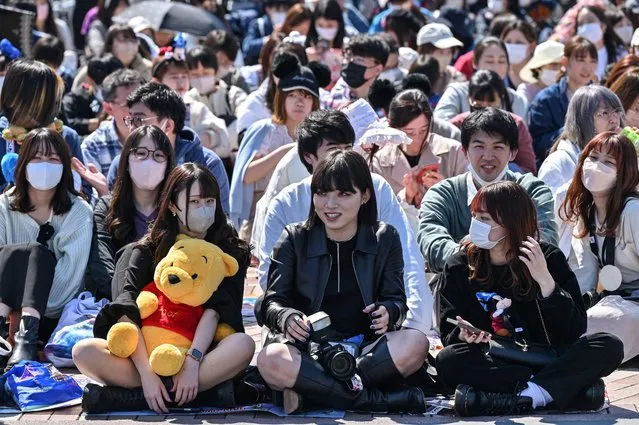 Visitors wait for the start of a new daytime parade to mark the 40th anniversary of Tokyo Disneyland in Urayasu, in suburban Tokyo on April 10, 2023. (Photo by Richard A. Brooks/AFP Photo)