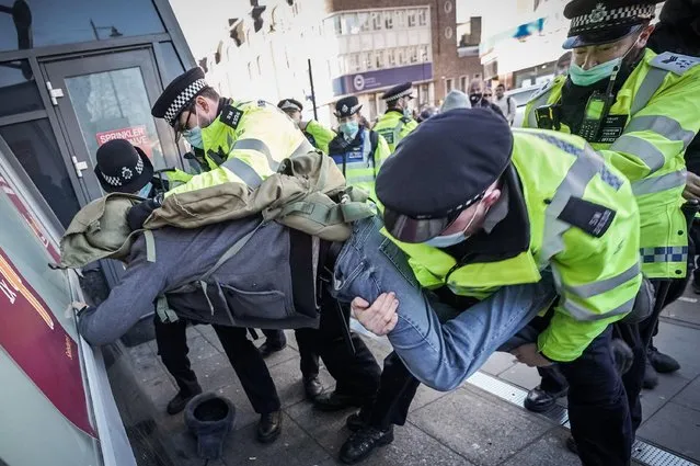 Man was arrested and taken to a police van in Clapham Common, London, United Kingdom on January 9, 2021. “Idiot” anti-lockdown mob clashes with cops after Covid kills 4,563 in four days (Photo by Velar Grant/ZUMA Wire/Alamy Live News)