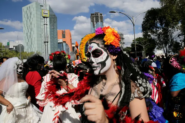A woman with her face painted as a skull or “Catrina” participates in the “Day of the Dead” parade in Mexico City, Mexico, October 29, 2016. (Photo by Carlos Jasso/Reuters)