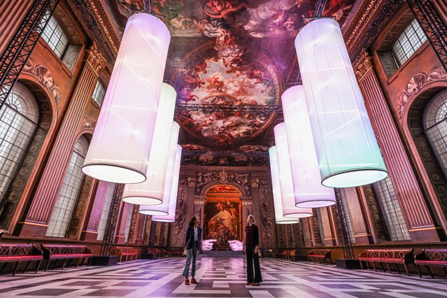 The majesty of the Painted Hall in London  on October 31, 2025 welcomes Peter Walker's Connection and Identity, offering two visual moments; gargantuan outstretched hands reminiscent of Michelangelo's Creation of Adam, and pulsing DNA-like suspended columns of light. Adorning the hall with streams of glowing colour and heavenly sculpture. (Photo by Paul Quezada-Neiman/Alamy Live News)